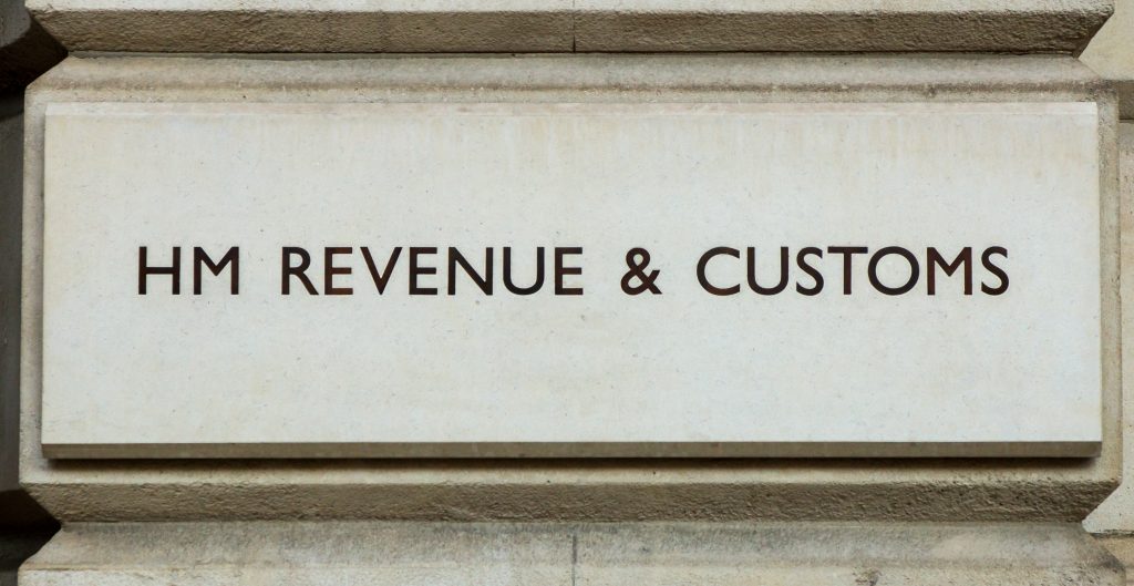 HMRC logo outside offices in stone wall