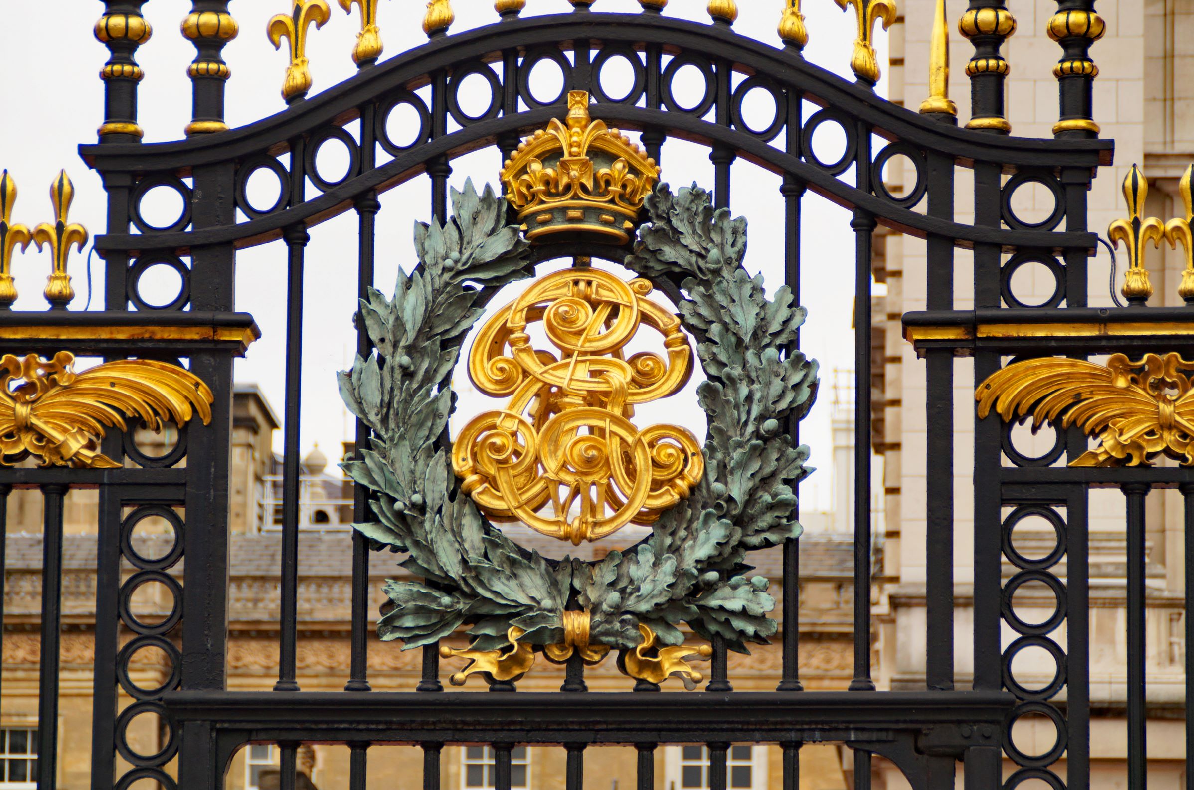 Gates of Buckingham Palace with royal insignia 