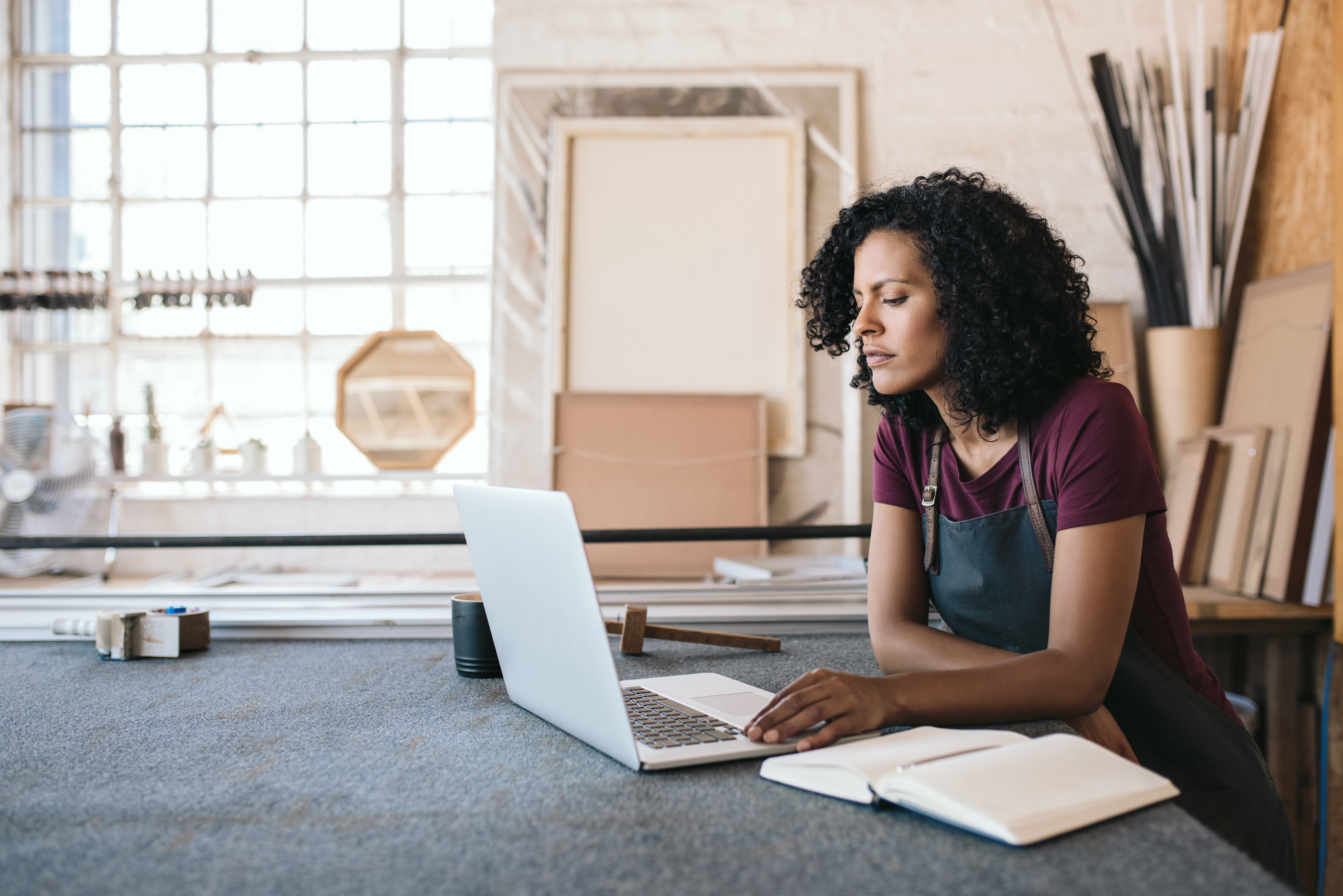 business woman looking at laptop in studio