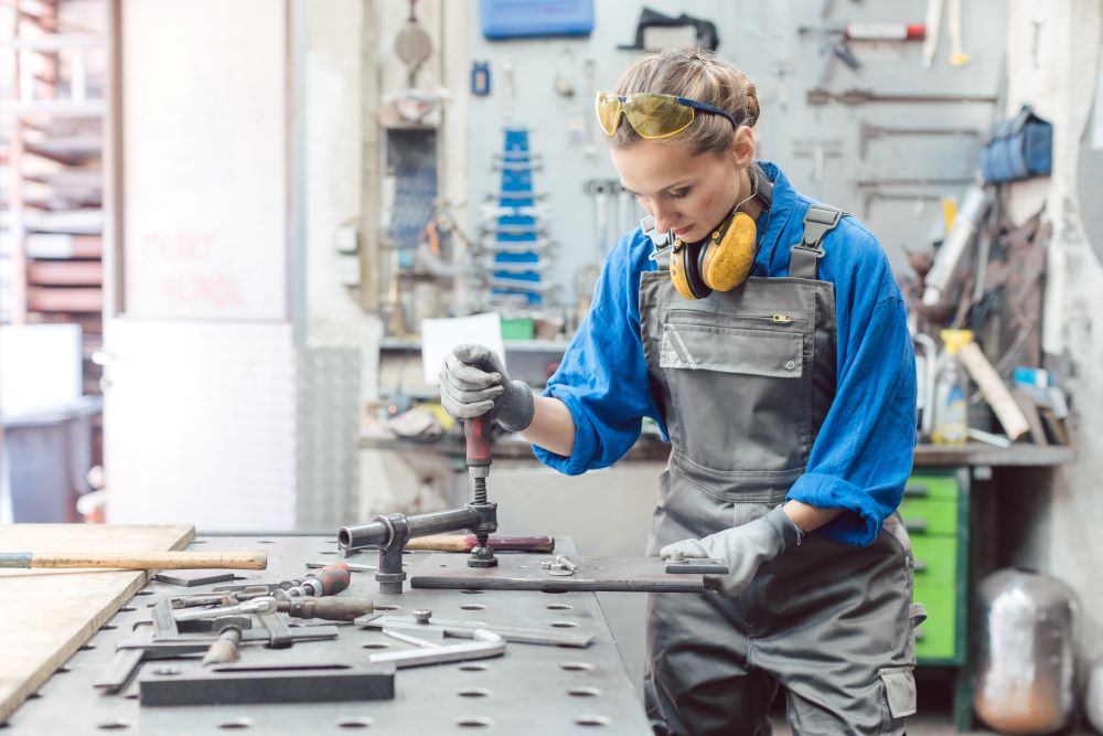 Female manufacturer in a factory with equipment