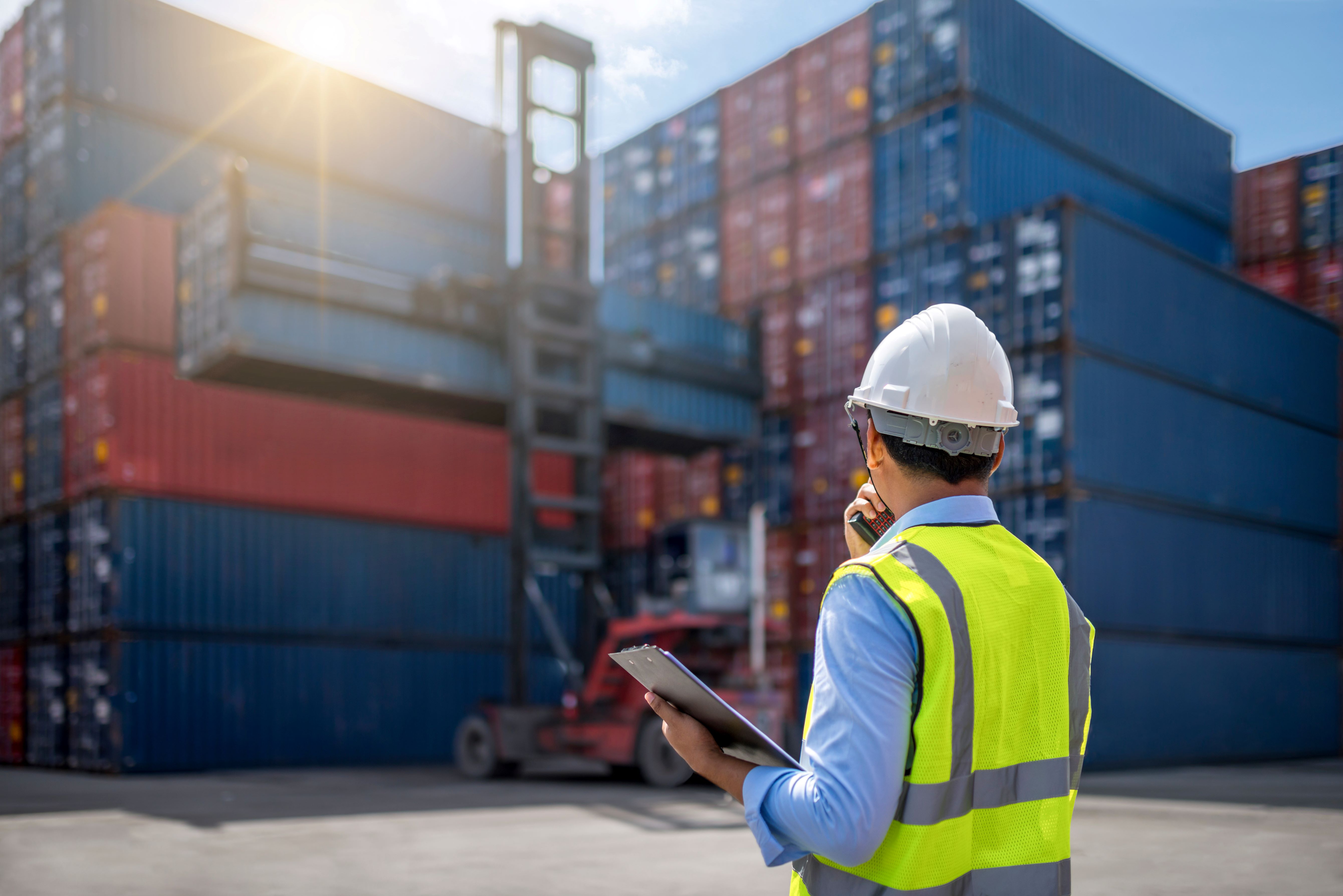 Worker In Front Of Freight Crates