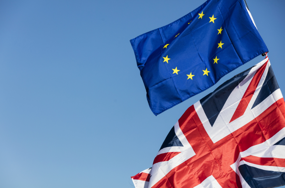 UK and EU flags billowing in the sky