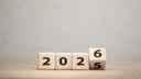 Wooden blocks with numbers, showing '2025' and slowly turning over to reveal '2026' 